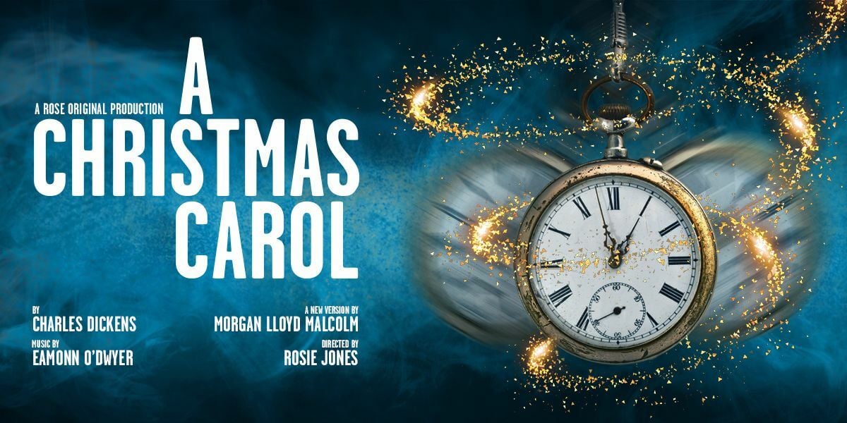 Text: A Rose Original Production. A Christmas Carol. By Charles Dickens. Music by Eamonn O'Dwyer. A new version by Morgan Lloyd Malcolm.  Directed by Rosie Jones. | Image: A pocket watch swings back and forth with a swirl of glittering gold surrounding it. 