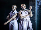 Two men in purple tops standing next to each other in A Strange Loop