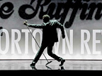 One of the Temptations in silhouette with a microphone on a stand at an angle