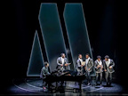 The Temptations around the piano in from of the Motown logo