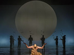 Image: Zachary James infront of a set of shadowed figures and a moon.