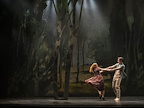 Man and woman dancing in a woodland setting
