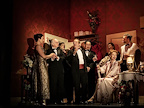 A group of people in evening wear meeting in a theatre dressing room.