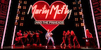 Back To The Future The Musical in London. Marty is performing with his band, Marty McFly and the Pinheads. The band name is hanging above them on a lit-up heart.