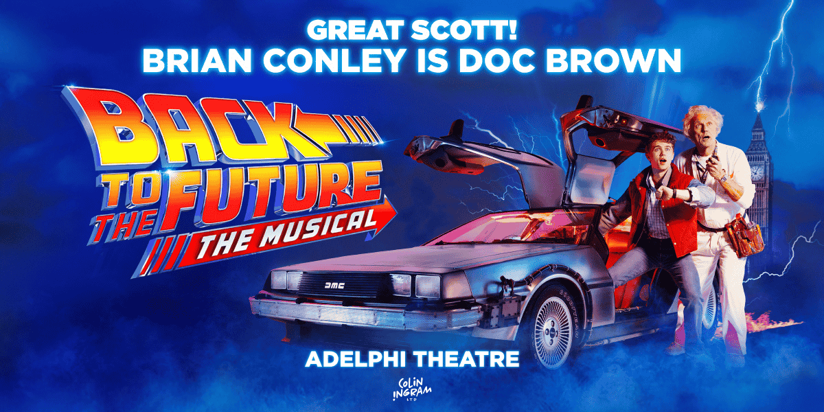 Man in red gillet along side man in white overalls in Back To The Future: The Musical 