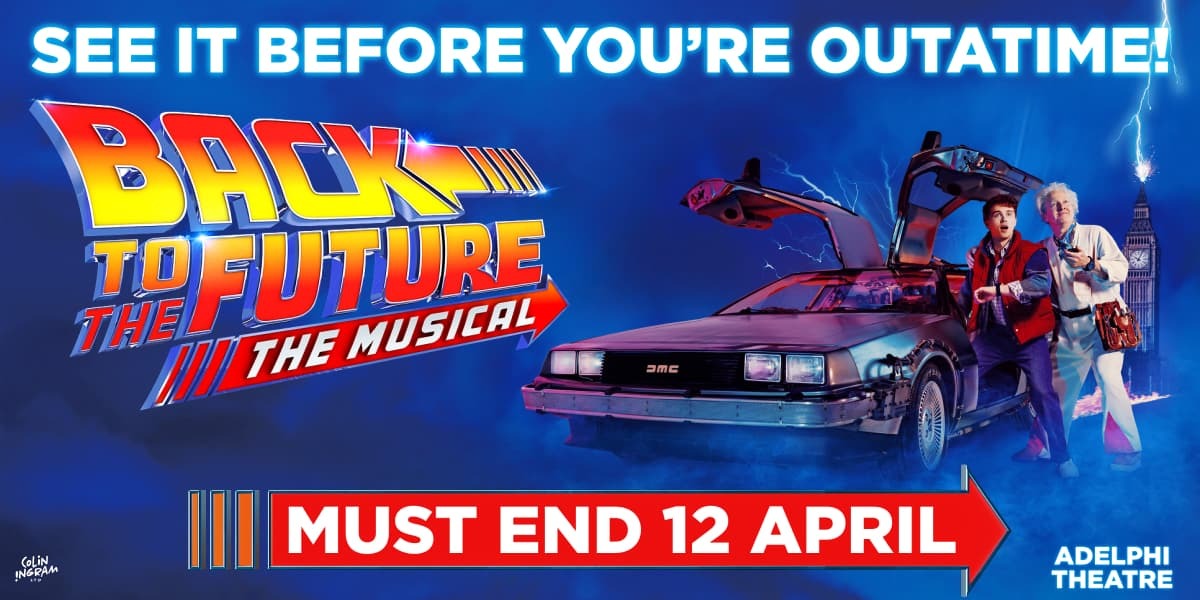 Man in red gillet along side man in white overalls in Back To The Future: The Musical