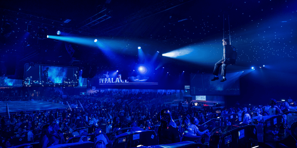Photo by Matt Crockett - Danny suspended in the air over the audience, with the night sky in the background