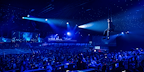 Photo by Matt Crockett - Danny suspended in the air over the audience, with the night sky in the background