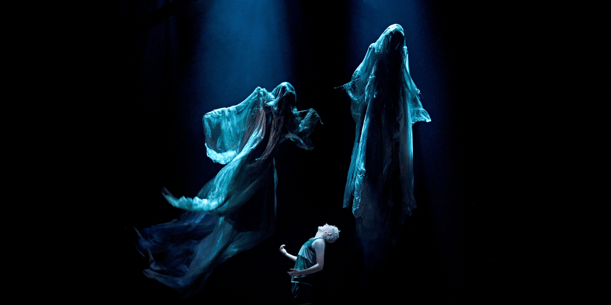 Two dementors float in darkness above Scorpius.