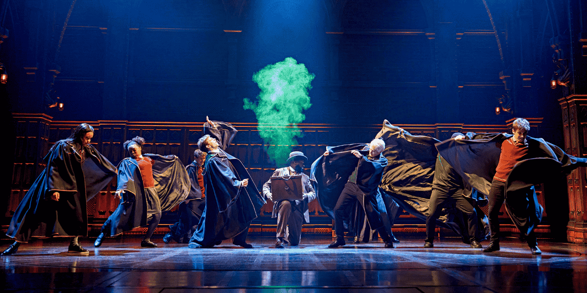 Image: A group of Hogwarts students surrounded by magical green smoke. Show: Harry Potter and the Cursed Child