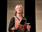 Danyah Miller on stage holding a book