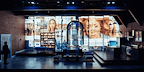 Show: Interview at Riverside Studios Image: A studio apartment with walls illuminated by projections of multiple social media profiles of the same person