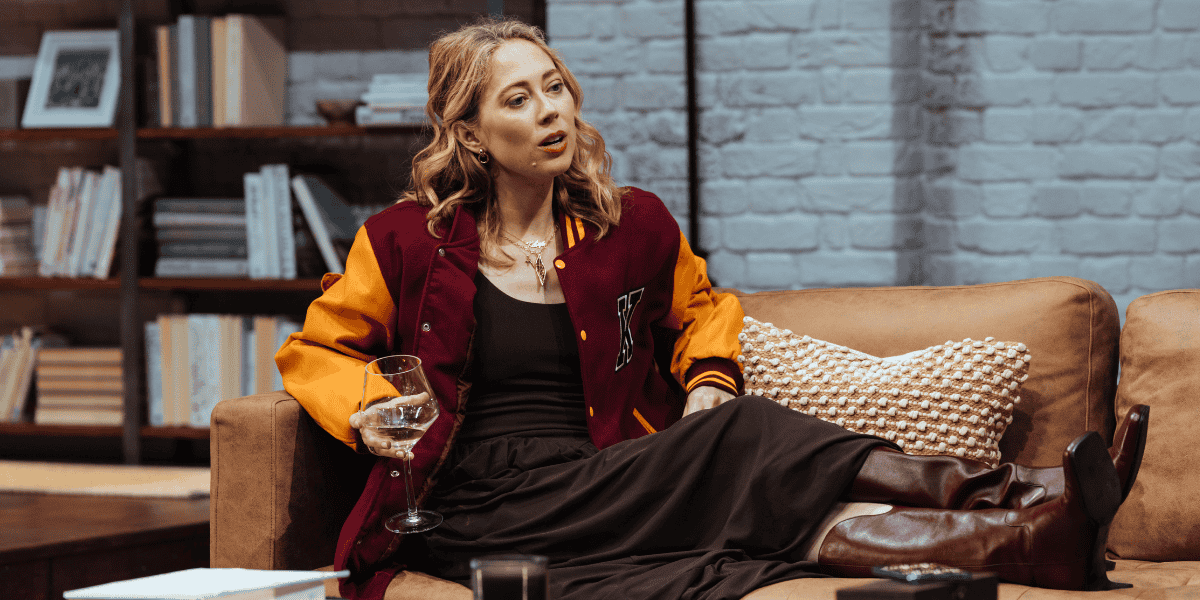 Show: Interview at Riverside Studios Image: A woman lounging on a sofa in a living room, whilst in conversation