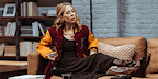 Show: Interview at Riverside Studios Image: A woman lounging on a sofa in a living room, whilst in conversation