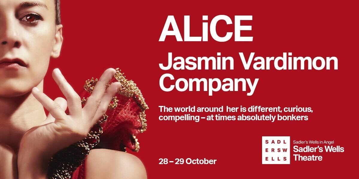 Text: ALiCE, Jasmin Vardimon Company. The world around her is different, curious, compelling - at times completely bonkers. 28-29 October. Sadler's Wells Company. Image: A woman half in the frame, staring intently towards the camera. Her eyes are reddish-brown, with a red and gold shoulder piece. The background is maroon.