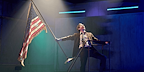 Image: Jack Holden on the top of stairs waving USA Flag Show: Kenrex