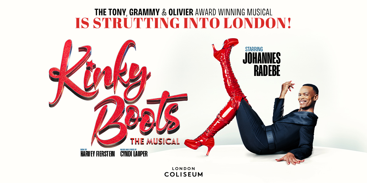 Johannes Radebe smiles at the camera, his knee high red boots are kicked out in front of him. Text reads: Kinky Boots