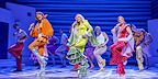 Donna and the Dynamo's each wear a brightly coloured flared jumpsuit whilst dancing