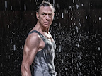 Man wearing a grey vest top in the rain