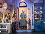 Mrs Doubtfire standing in the doorway while the Hillard family greet her