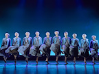 10 Mrs Doubtfires dancing in a line.