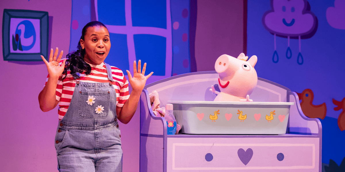 Woman in dungarees with a pig in a cot from Peppa Pig's Big Family Show! 