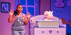 Woman in dungarees with a pig in a cot from Peppa Pig's Big Family Show! 