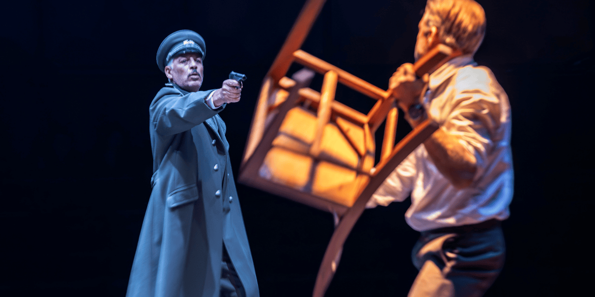 Man pointing a gun at man holding a chair in The Spy Who Came In From The Cold