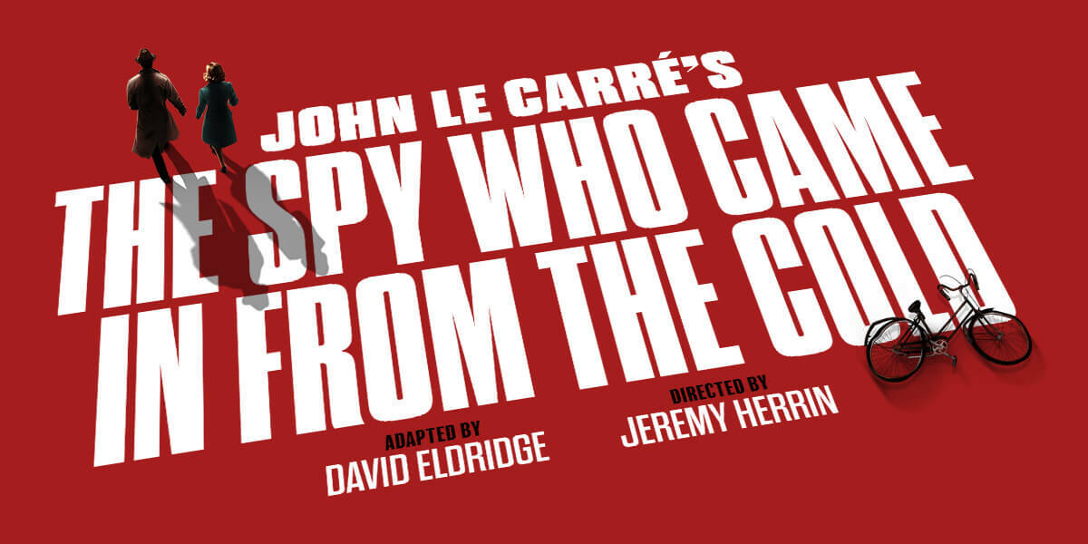The Spy Who Came In From The Cold. White writing against a red background. Two figures seen in the distance