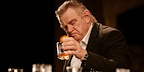 Brendan Gleeson has a glass of whiskey in The Weir
