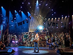 Ben Elton as Rebel Leader with We Will Rock You cast Photo Credit; Manuel Harlan