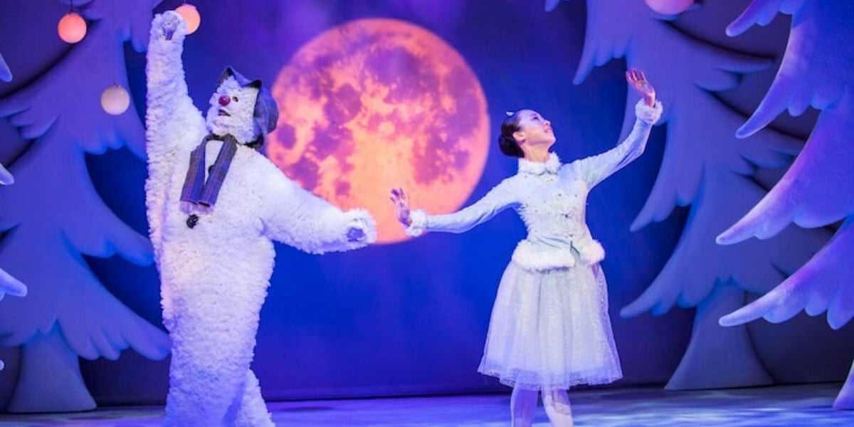 The Snowman dances with a ballerina in a wintry scene