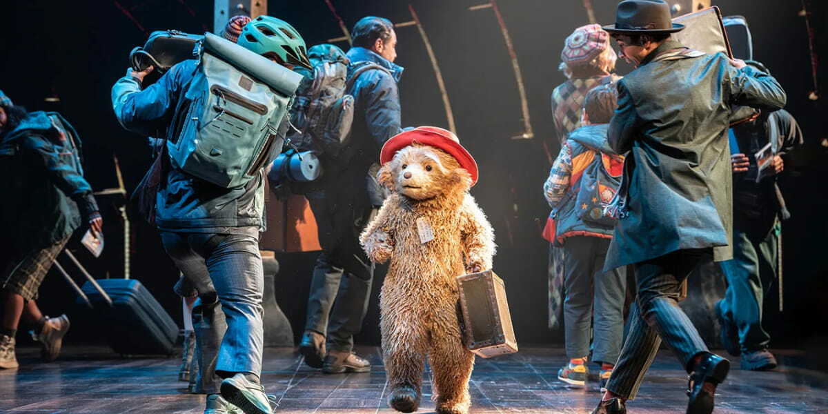 Paddington giving his signature Hard Stare as the Brown family watch on in Paddington The Musical 