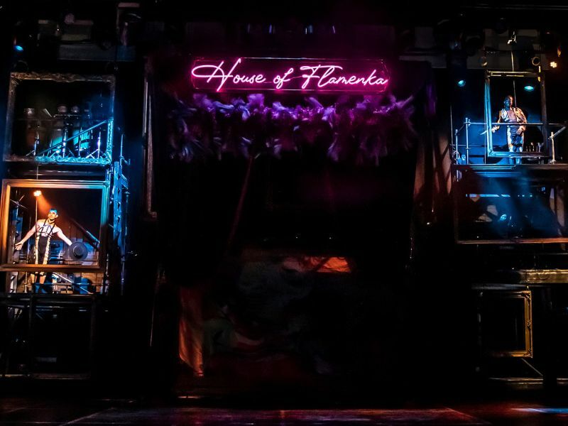Image: House of Flamenka neon sign above a dark stage.