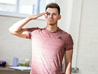 From Here To Eternity Rehearsals, male cast member wearing light red t shirt doing the salute sign. Photo by Pamela Raith.