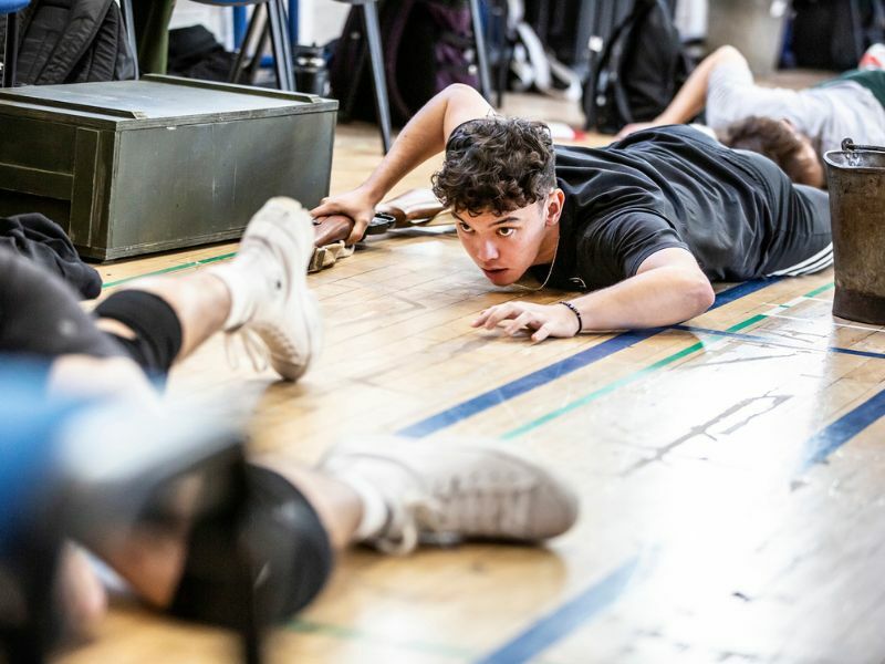 Rehearsals for From Here To Eternity, male cast members crawling along floor. Photo by Pamela Raith.
