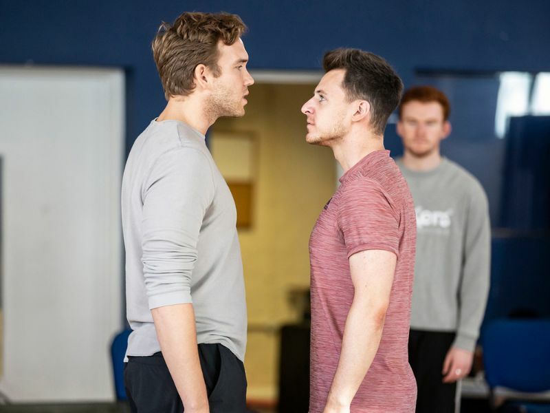 Rehearsals for From Here To Eternity, two male cast members interacting. Photo by Pamela Raith.