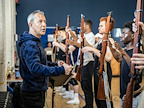 Rehearsals for From Here To Eternity. Cast members carrying weapons. Photo by Pamela Raith..