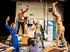 Performers hold objects up in the air
