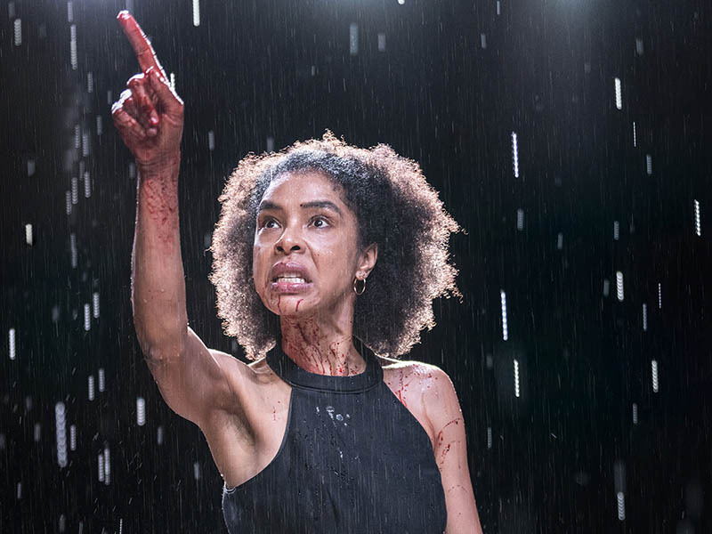 Woman pointing to the sky in the rain