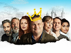 A group of smiling individuals poses together, with a playful crown drawn above one person’s head. The backdrop features a sketch of a castle, adding a whimsical touch to the scene.