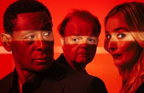  David Harewood, Toby Jones and Caitlin FitzGerald stand in front of a red background